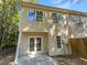 Two-story townhome with double doors leading to a patio at 20 Pine Canyon Sw Dr # 24, Atlanta, GA 30331