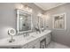 Elegant Primary bath featuring dual vanities, large mirrors, and tile flooring at 1085 Queensgate Se Dr, Smyrna, GA 30082