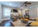 Bright living room featuring hardwood floors, cozy armchairs, and a large TV at 2130 Perkerson Mill Rd, Austell, GA 30106
