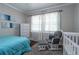Spacious bedroom with hardwood floors and a rocking chair at 2130 Perkerson Mill Rd, Austell, GA 30106