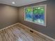 Spacious bedroom with wood-look tile flooring and large window at 6095 Blackberry Ln, Buford, GA 30518