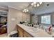 Elegant bathroom with double sinks, a large soaking tub, and a view into a spacious bedroom at 1720 Mountainside Dr, Cumming, GA 30040