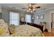 Bright bedroom featuring a floral comforter, hardwood floors, and ample natural light at 1720 Mountainside Dr, Cumming, GA 30040