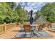 Relaxing deck with seating for six, an umbrella, and wooded views at 1720 Mountainside Dr, Cumming, GA 30040