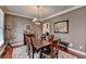 Formal dining room with hardwood floors, a chandelier, and a large window at 1720 Mountainside Dr, Cumming, GA 30040