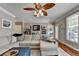 Open living room with sectional sofa, hardwood floors, and access to patio at 1720 Mountainside Dr, Cumming, GA 30040