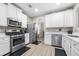 Modern kitchen with stainless steel appliances and white cabinets at 6060 Hemperly Rd, Atlanta, GA 30349