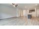 Open concept living room with wood-look flooring and view of kitchen at 4271 Portsbrook Ave, Snellville, GA 30039