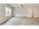 Spacious living room with wood-look flooring and lots of natural light at 4271 Portsbrook Ave, Snellville, GA 30039