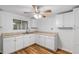 Efficient kitchen with white cabinets and vinyl flooring at 646 Old Cumming Rd, Sugar Hill, GA 30518