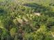 Aerial view showing a large lot with mature trees and a pond at 4885 Stout Pkwy, Powder Springs, GA 30127