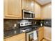 Well-equipped kitchen featuring stainless steel appliances and light wood cabinets at 2255 Peachtree Rd # 328, Atlanta, GA 30309