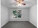 Bright bedroom with gray carpeting and a window overlooking trees at 3217 Fairington Dr, Lithonia, GA 30038