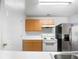 Kitchen with light wood cabinets, white appliances, and a double sink at 3217 Fairington Dr, Lithonia, GA 30038
