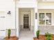 Inviting front porch with a dark-stained door and stone accents at 7375 Winderlea Ln, Cumming, GA 30040