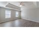 Main bedroom with tray ceiling, fan and hardwood floors at 1983 Smithfield Ave, Ellenwood, GA 30294