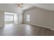 Bright bedroom featuring wood-look floors and multiple windows at 1983 Smithfield Ave, Ellenwood, GA 30294