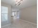 Bright dining room with tile floors and modern light fixture at 1983 Smithfield Ave, Ellenwood, GA 30294