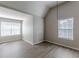 Well-lit bedroom with wood-look floors and large windows at 1983 Smithfield Ave, Ellenwood, GA 30294