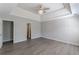 Main bedroom with tray ceiling, fan, and hardwood floors at 1983 Smithfield Ave, Ellenwood, GA 30294
