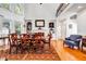 Dining room with high ceilings, large windows, a fireplace, and hardwood floors at 4685 Jailette Trace, Atlanta, GA 30349