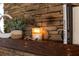 Rustic wood mantel with candles and decor above fireplace at 1880 Vesta Ave, Atlanta, GA 30337
