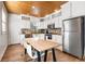 Bright kitchen with white cabinets, stainless steel appliances and wood floors at 1880 Vesta Ave, Atlanta, GA 30337