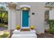 Welcoming teal front door with potted mums at 1880 Vesta Ave, Atlanta, GA 30337