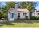 Charming single story home with teal door and manicured lawn at 1880 Vesta Ave, Atlanta, GA 30337