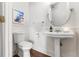 Clean bathroom with pedestal sink and wood floors at 1880 Vesta Ave, Atlanta, GA 30337