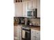 Kitchen details: granite countertop and stainless steel appliances at 1880 Vesta Ave, Atlanta, GA 30337