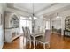 Bright dining room with hardwood floors, large windows, and a formal dining set at 23 Waterstone Se Dr, Cartersville, GA 30121