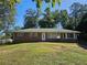 Brick ranch house with a green roof and grassy yard at 3801 Orchard Se Rd, Smyrna, GA 30080