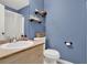 Small bathroom with toilet, sink, and floating shelves at 221 Cliff Nelson Rd, Euharlee, GA 30145