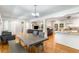 Open concept dining area with grey table and view into the living room and kitchen at 3113 Octavia Pl, Atlanta, GA 30340