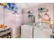 Bright laundry room with washer, dryer, and ample shelving at 3113 Octavia Pl, Atlanta, GA 30340