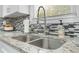 Double stainless steel kitchen sink with granite countertop and modern faucet at 2115 Tudor Castle Cir, Decatur, GA 30035