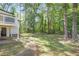 Landscaped backyard with large trees and a deck at 2115 Tudor Castle Cir, Decatur, GA 30035