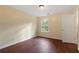 Well-lit bedroom featuring wood-look flooring and a window at 3869 Merryweather Trl, Austell, GA 30106