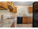 Kitchen with oak cabinets, granite countertops and gas stove at 3869 Merryweather Trl, Austell, GA 30106