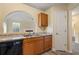 Kitchen with wood cabinets, granite countertops, and black appliances at 3869 Merryweather Trl, Austell, GA 30106