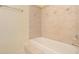 Bathroom with tiled tub surround and a shower/tub combo at 3869 Merryweather Trl, Austell, GA 30106