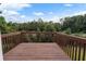Wooden deck overlooking a wooded area with a partial view of the road at 3869 Merryweather Trl, Austell, GA 30106