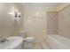 Bathroom with tiled walls, a pedestal sink, toilet and step-in tub at 3869 Merryweather Trl, Austell, GA 30106