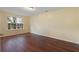 Spacious bedroom with dark wood-look flooring and a large window at 3869 Merryweather Trl, Austell, GA 30106