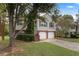 Two-story house with a two-car garage and landscaped lawn at 3869 Merryweather Trl, Austell, GA 30106