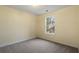 Bright bedroom with neutral walls, carpet flooring, and a window at 3869 Merryweather Trl, Austell, GA 30106
