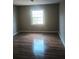 Bright bedroom with wood flooring and large window at 172 Rue Fontaine, Lithonia, GA 30038