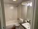 Clean bathroom featuring a bathtub, toilet, and vanity with sink at 172 Rue Fontaine, Lithonia, GA 30038