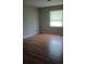 Bright bedroom with wood flooring and a window with blinds at 172 Rue Fontaine, Lithonia, GA 30038